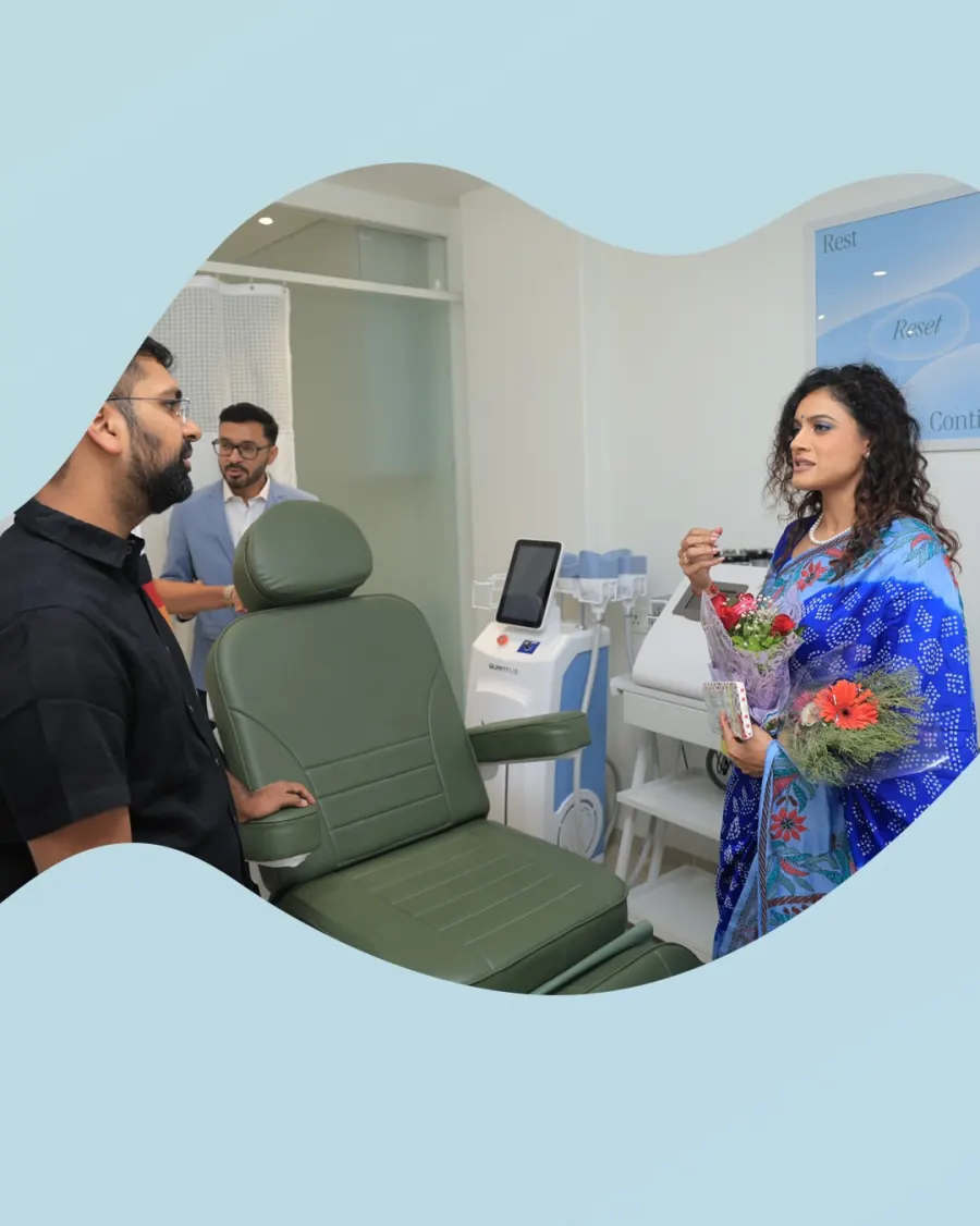 Dr. Twinkle Gohil with guests and flowers in the treatment room
